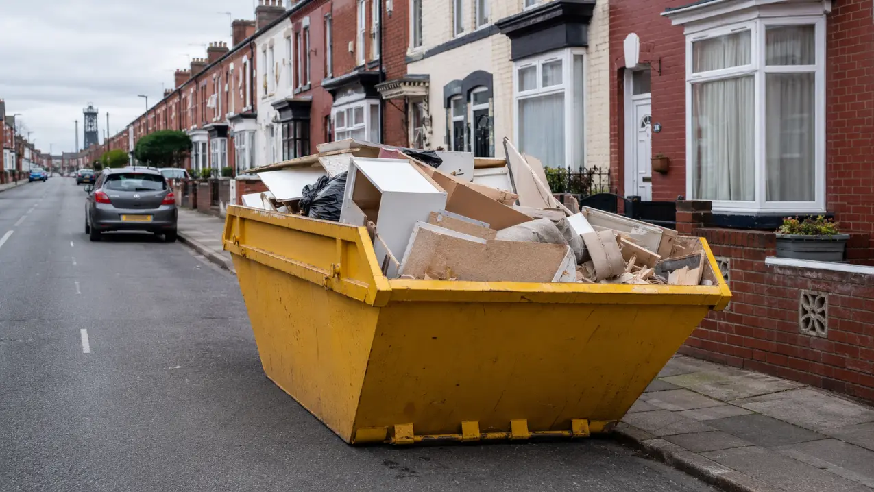 Skip on a residential street in Doncaster, part filled with household and building waste